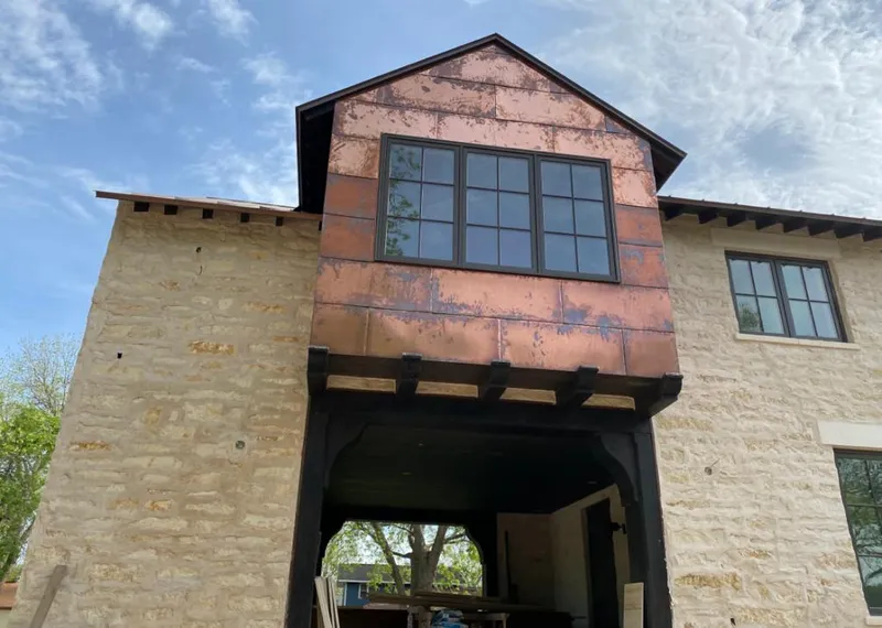 Copper metal panel facade on a stone building for Skylight Installation in South Lake Tahoe